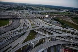 An aerial view of a busy highway intersection in a city.