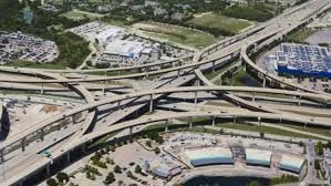 An aerial view of a highway intersection in a city.