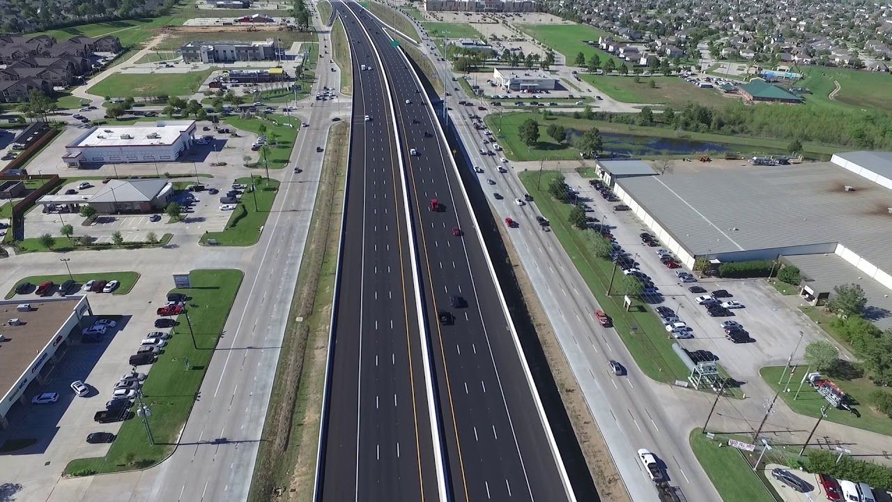 An aerial view of a busy highway intersection in a city.
