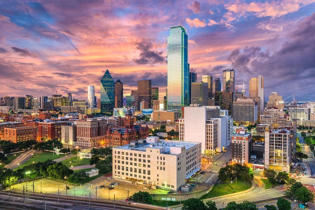 An aerial view of a city skyline at sunset.