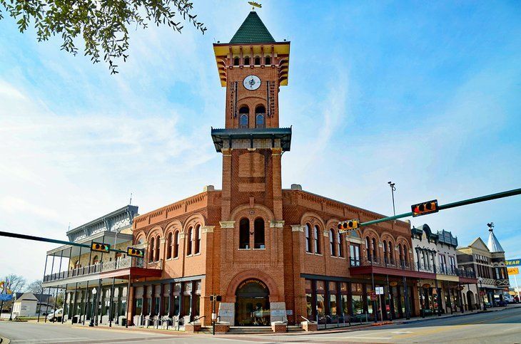 A large brick building with a clock tower on top of it.