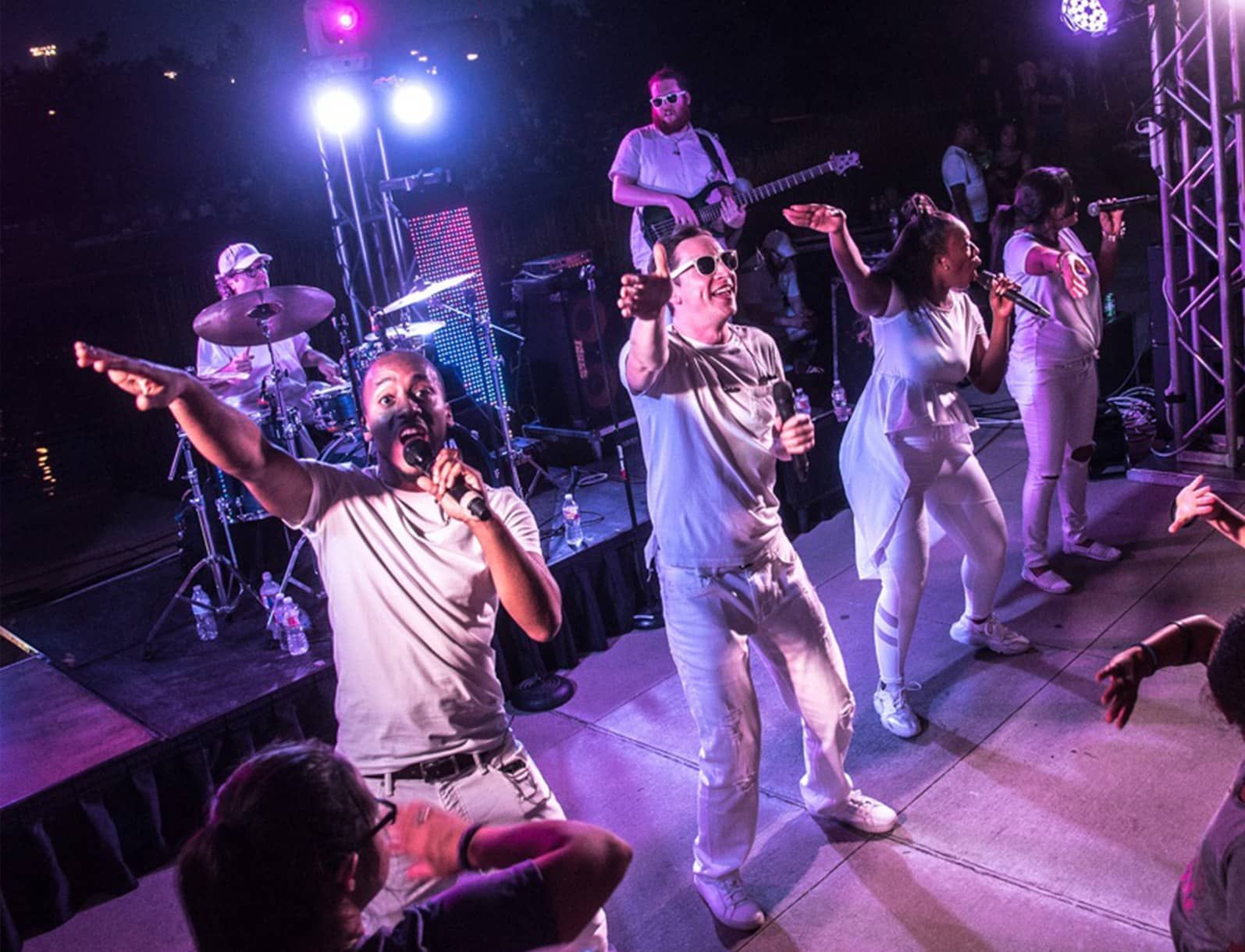 A group of people are singing and dancing on a stage.