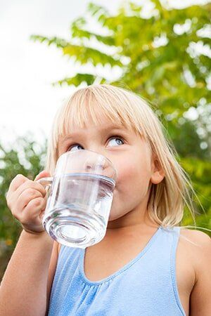 Child drinking water outdoors — Water Filtration in Orem, UT