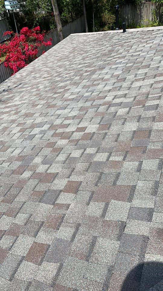 Shingled roof with a blend of brown, gray, and tan shingles.