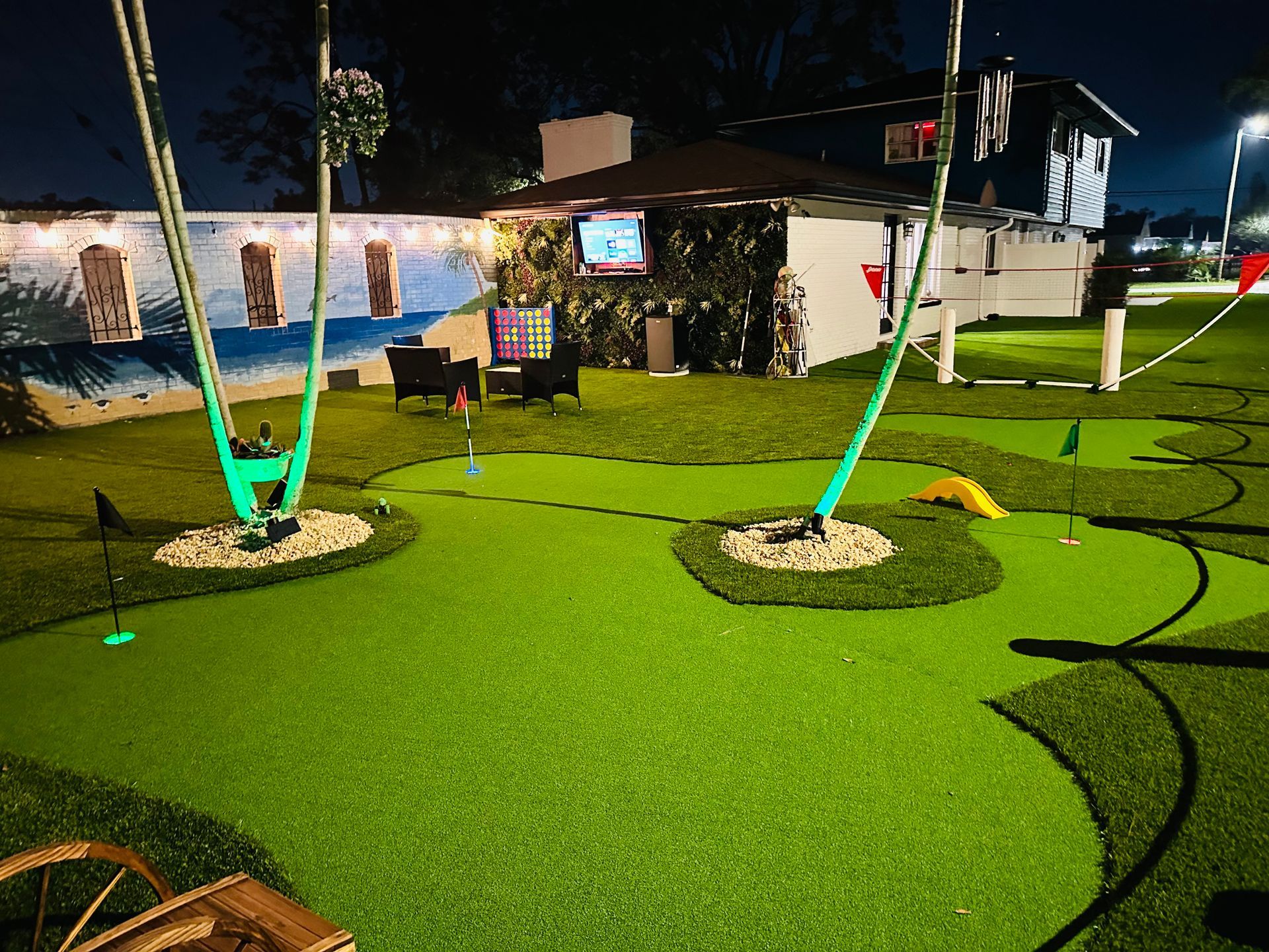 Roll of sod on a wooden pallet, showing green grass and brown soil.