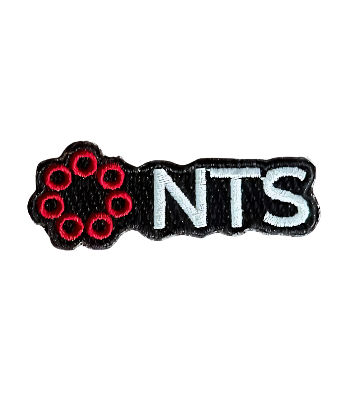 A black and white patch with the word nts on it.