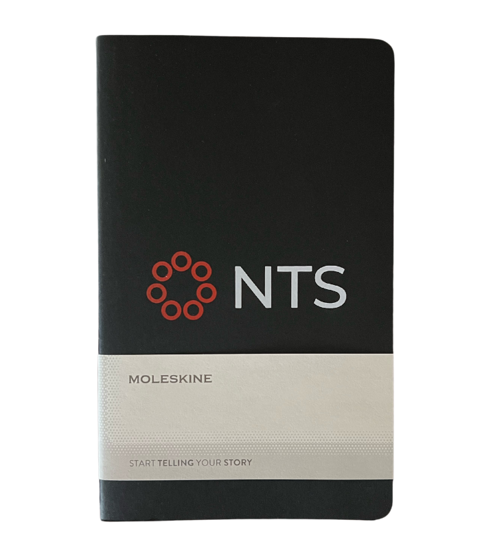 A black moleskine notebook with the word nts on it