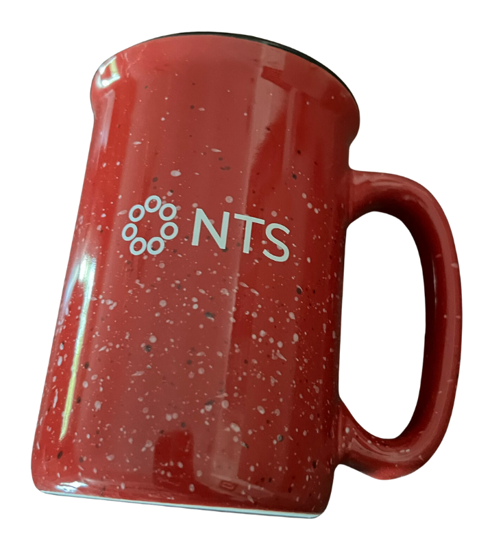 A red mug with the word nts on it