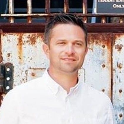 a man with a beard wearing a suit and tie