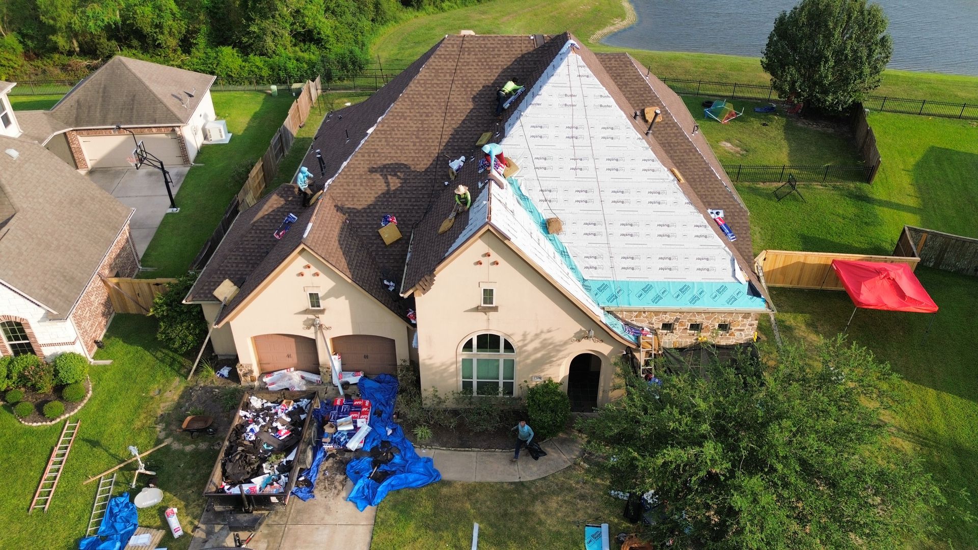 An aerial view of a house being remodeled with a roof being installed.