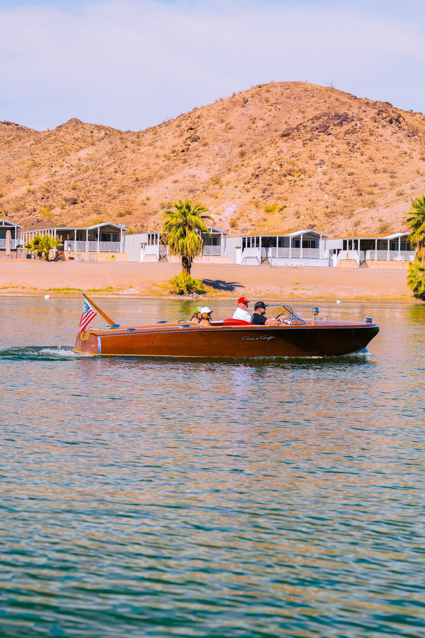A boat is floating on a lake with mountains in the background.