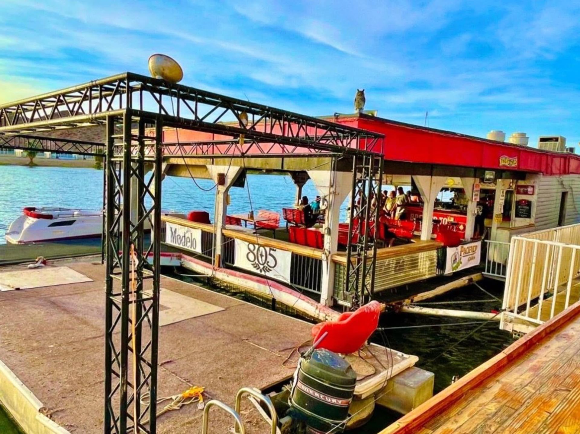 A boat is docked at a dock next to a body of water.