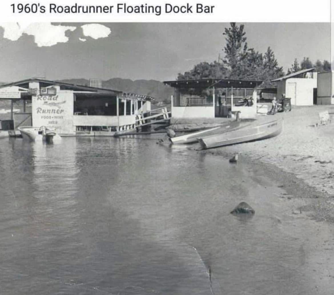 A black and white photo of a 1960 's roadrunner floating dock bar