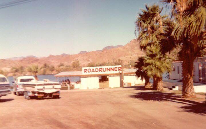 A truck is parked in front of a building that says roadrunner