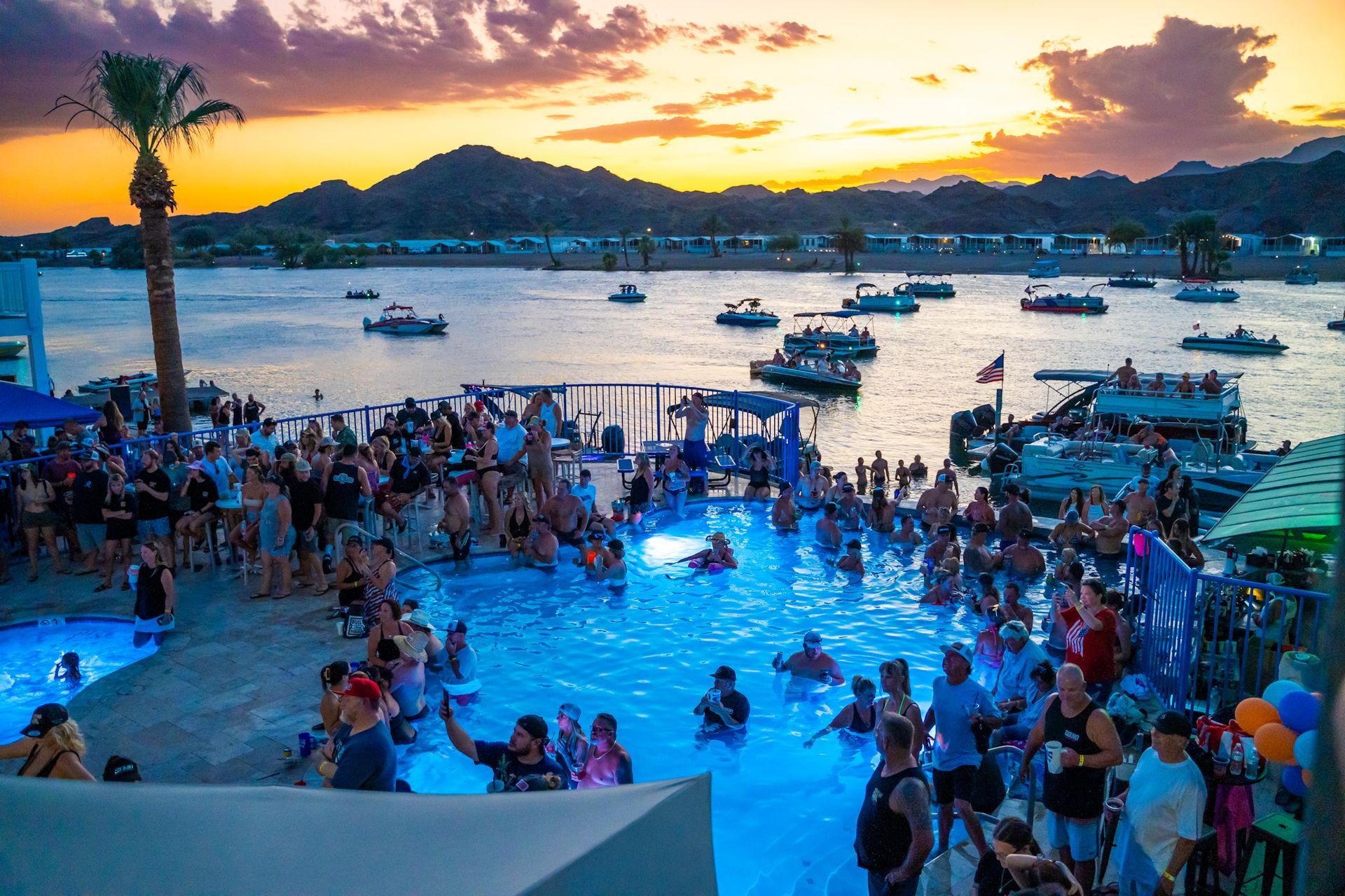 A large group of people are swimming in a large pool.