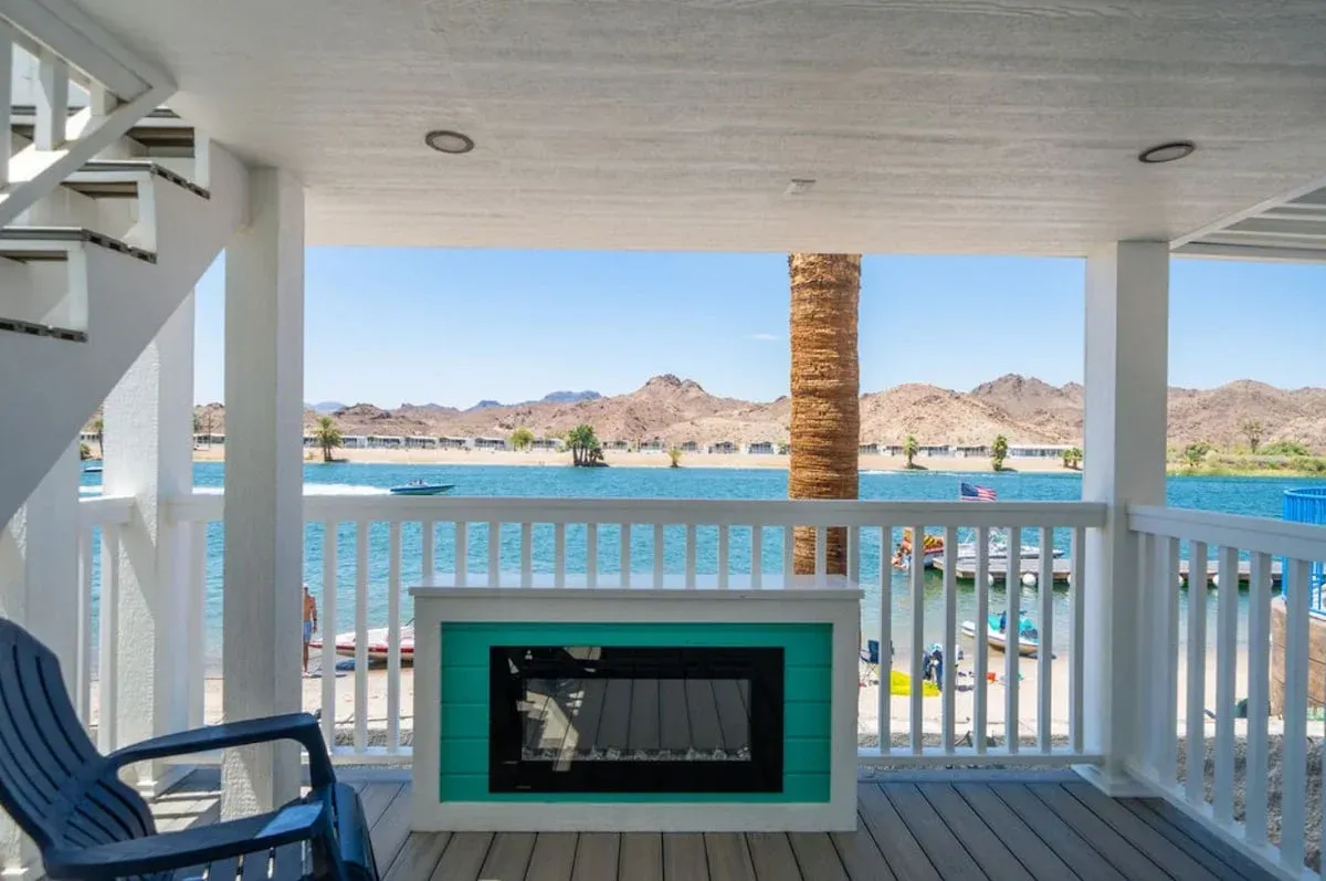 A balcony with a fireplace and a view of the ocean