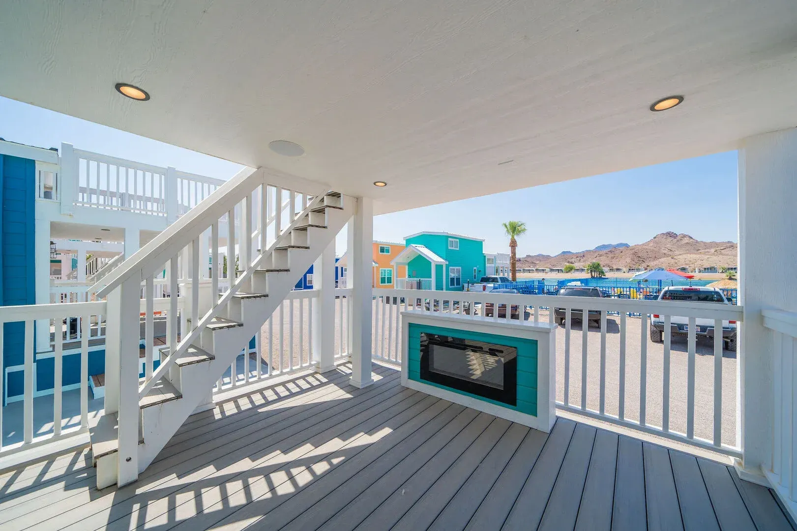 A deck with stairs and a fireplace on it.