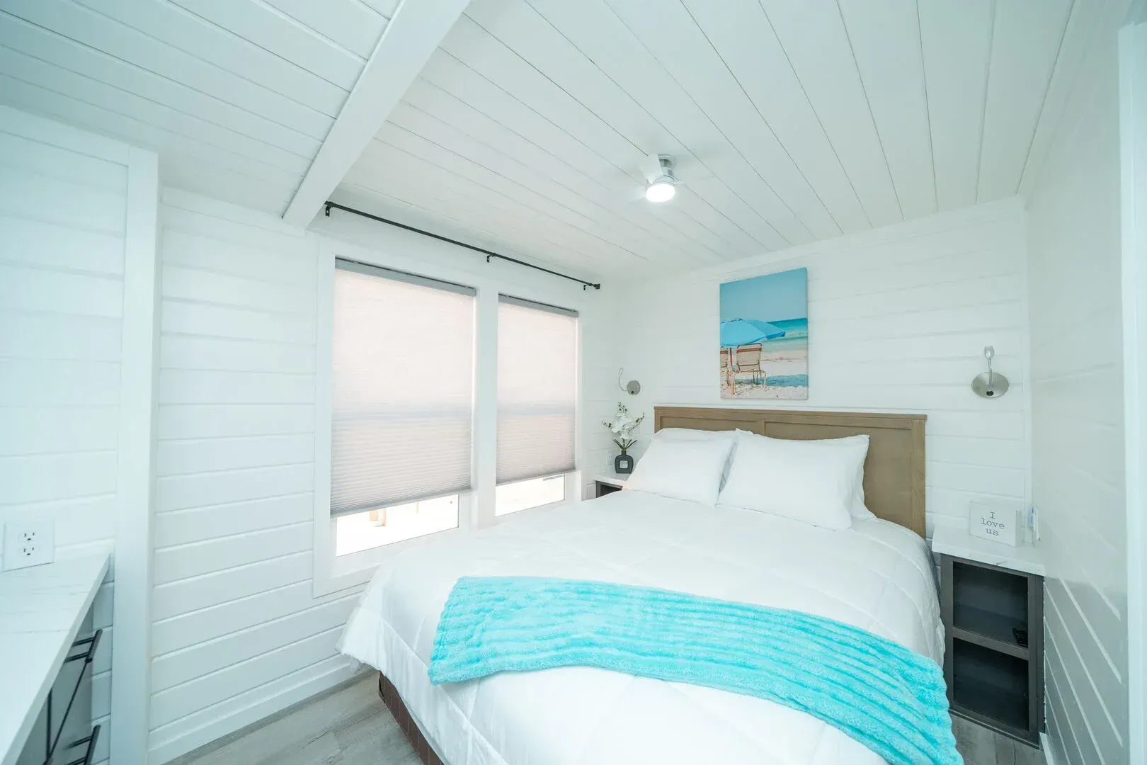 A bedroom with a king size bed and a blue blanket.