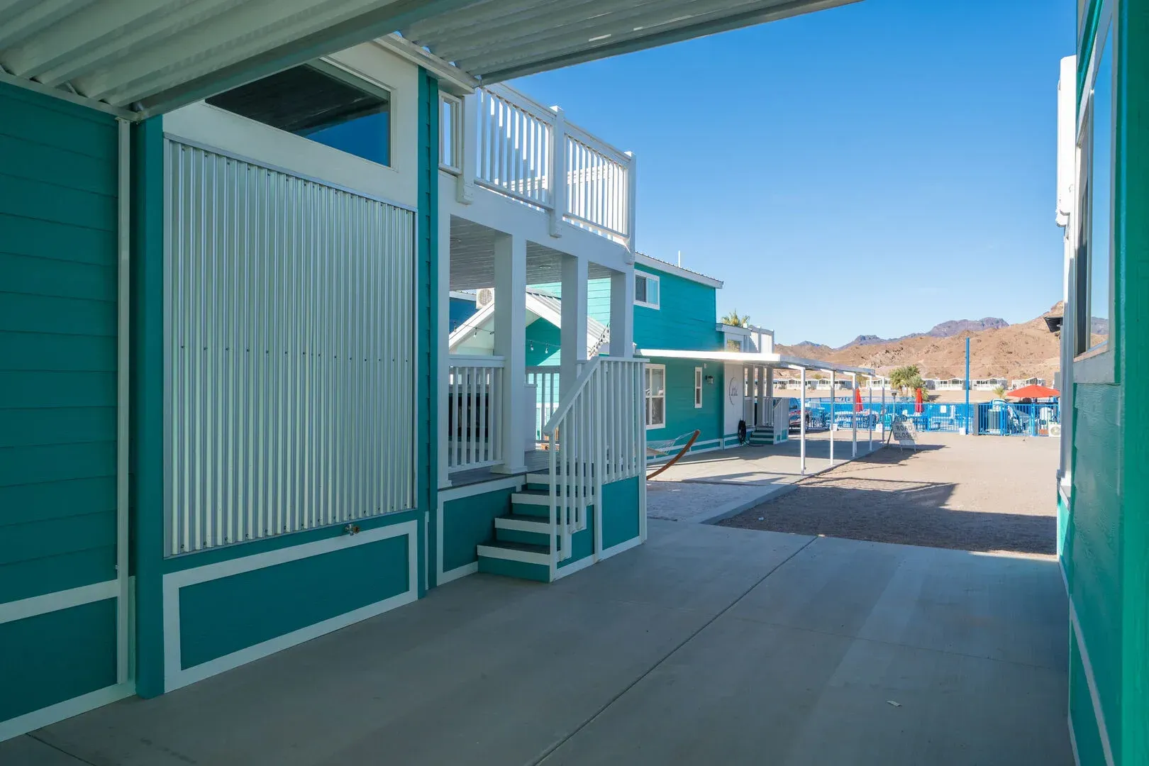 A blue and white building with stairs leading up to it.