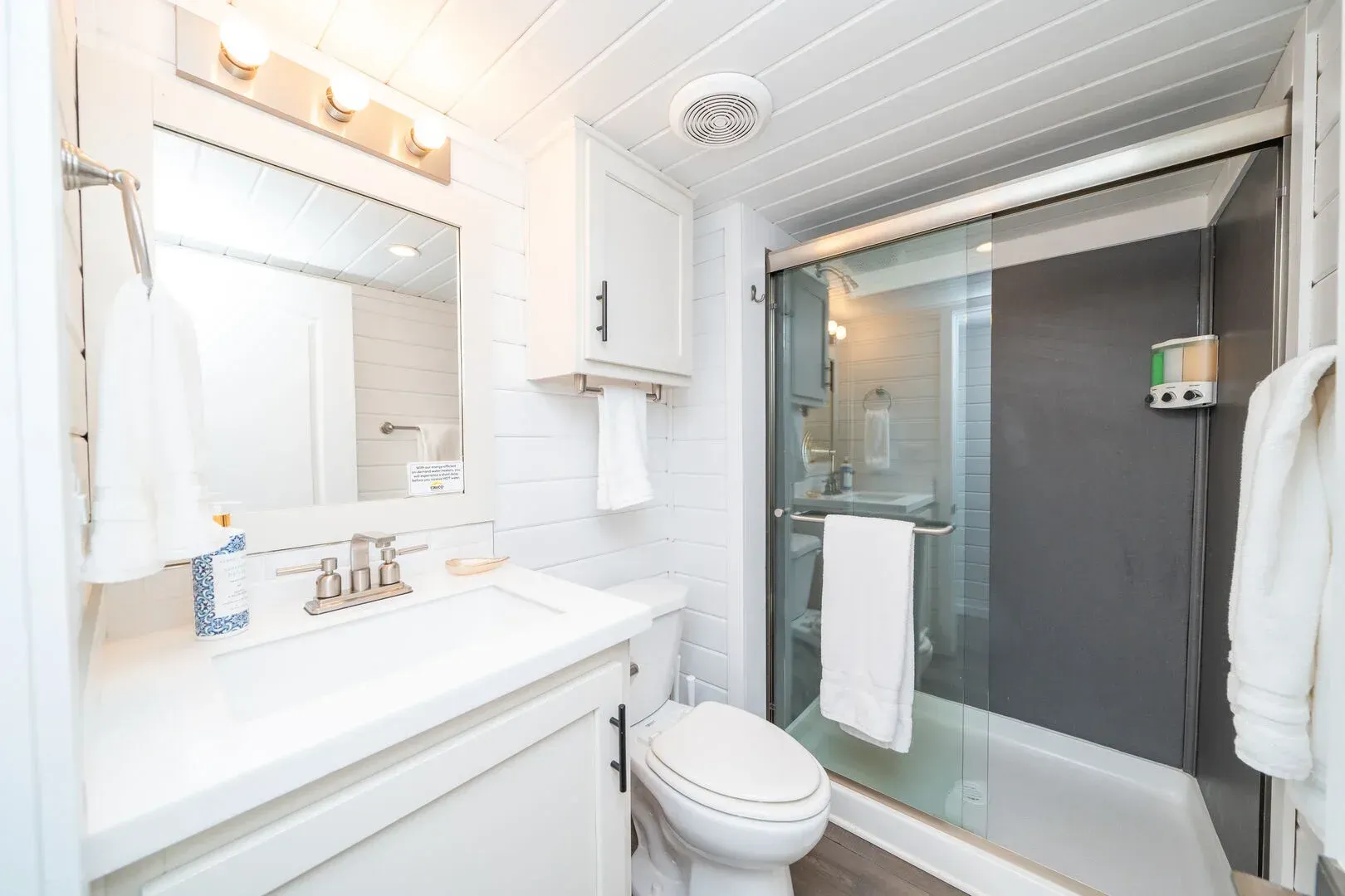 A bathroom with a toilet , sink , and shower.