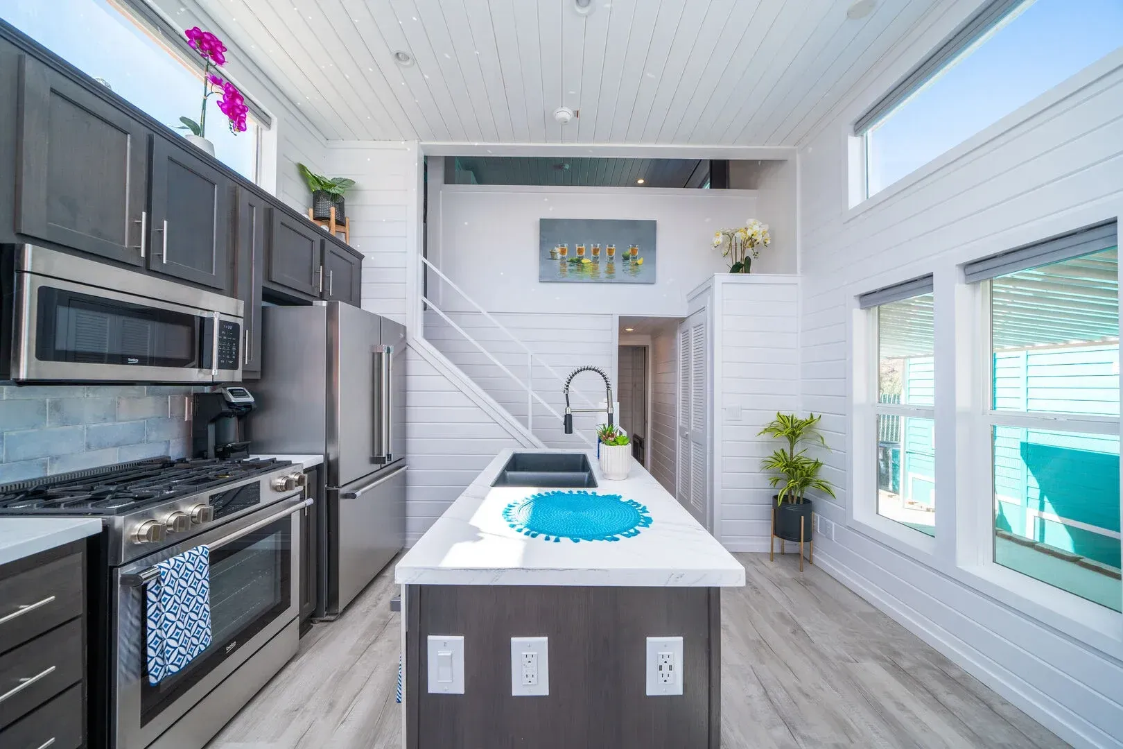 A kitchen with stainless steel appliances and a large island.