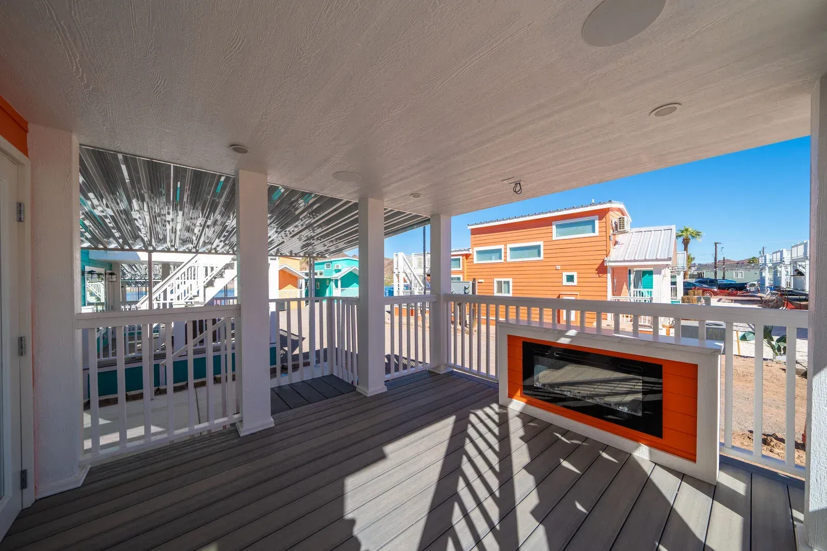 There is a fireplace on the porch of a house.