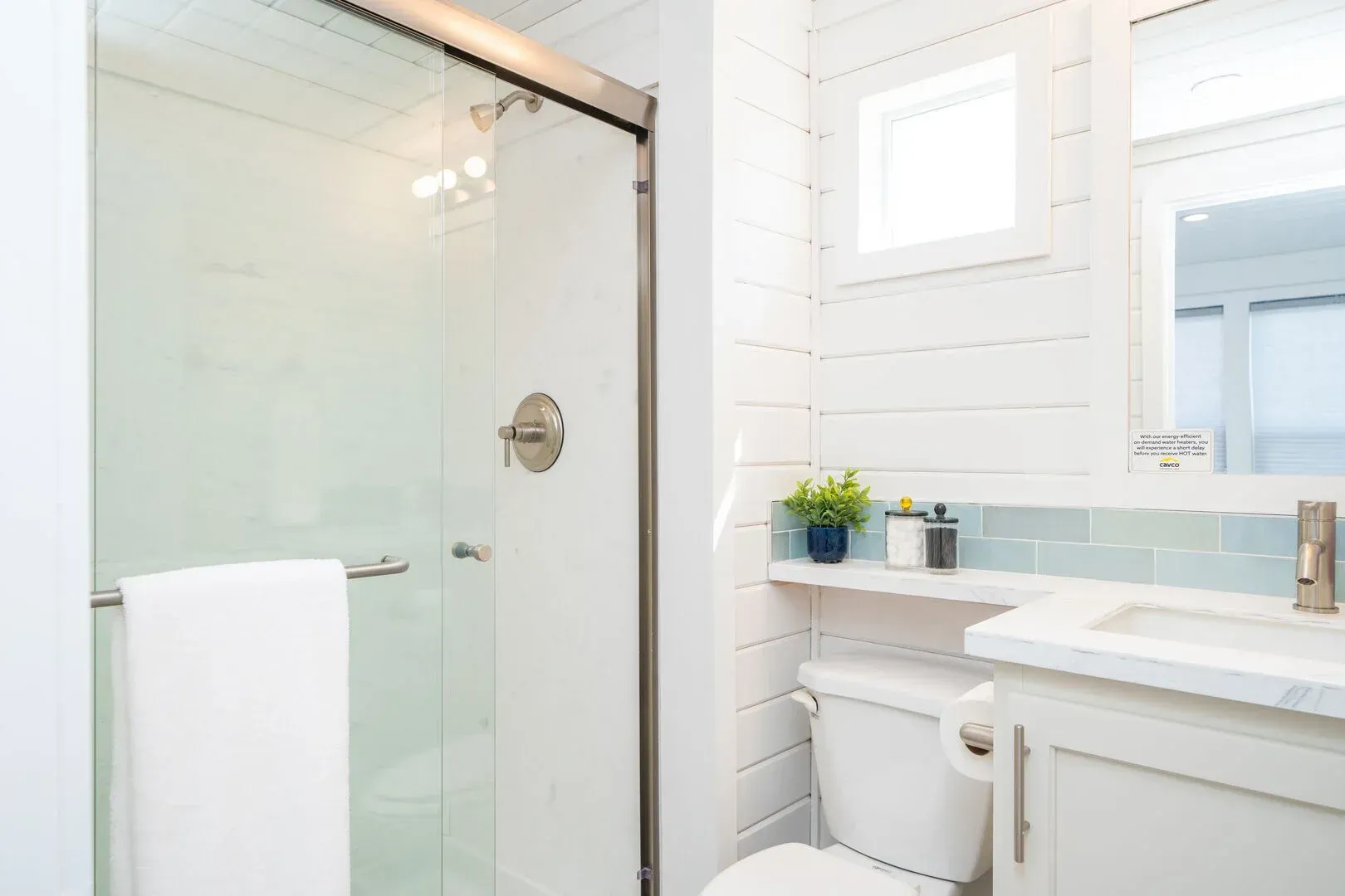 A bathroom with a toilet , sink , and shower.