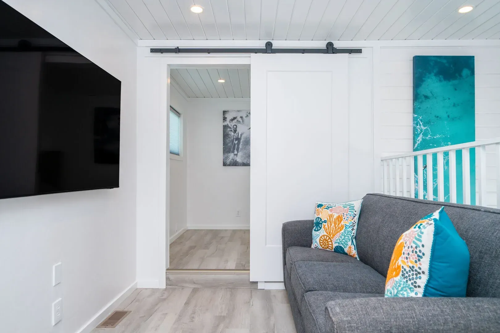 A living room with a couch and a flat screen tv.