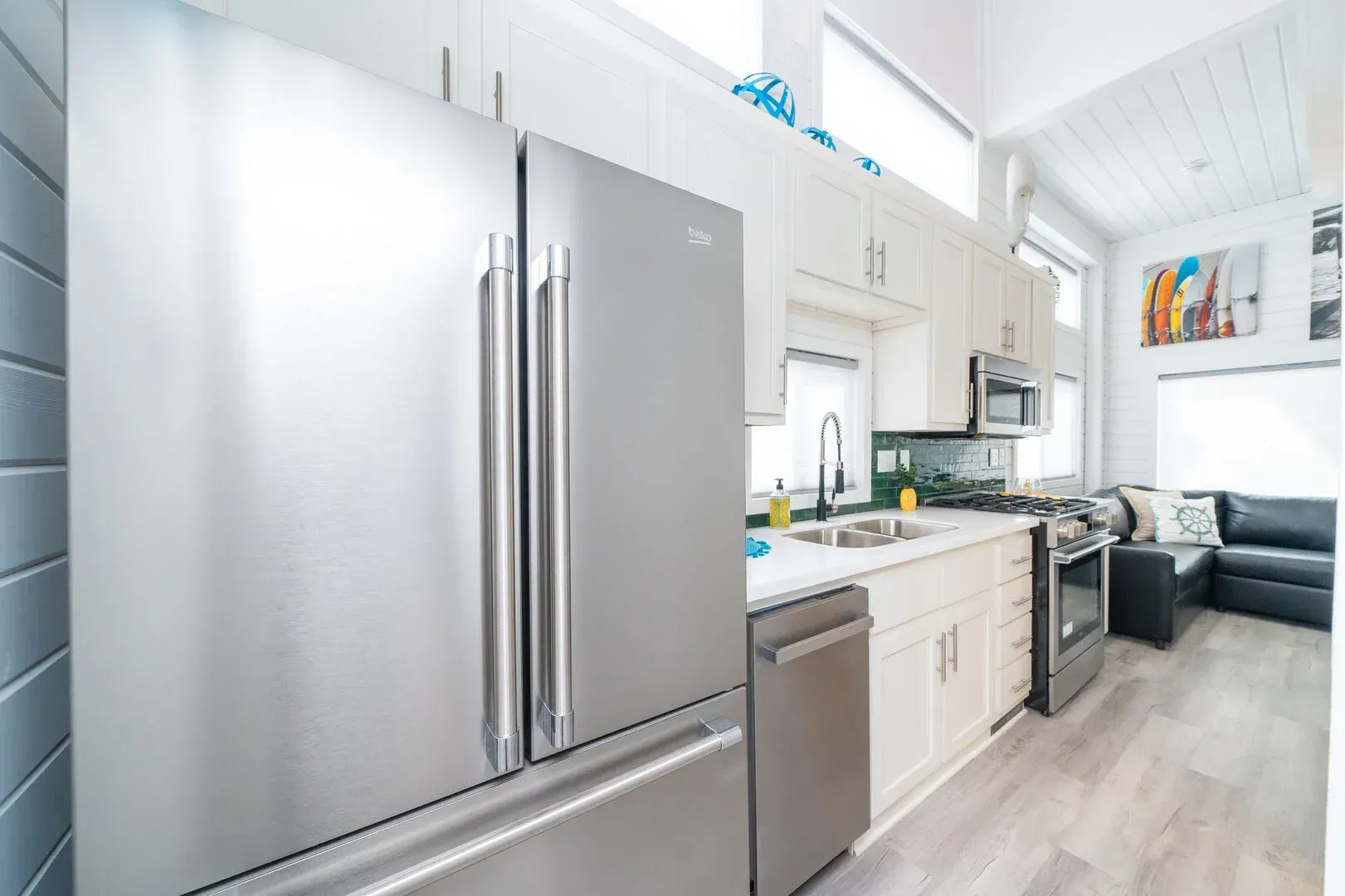 A kitchen with stainless steel appliances and a stainless steel refrigerator.