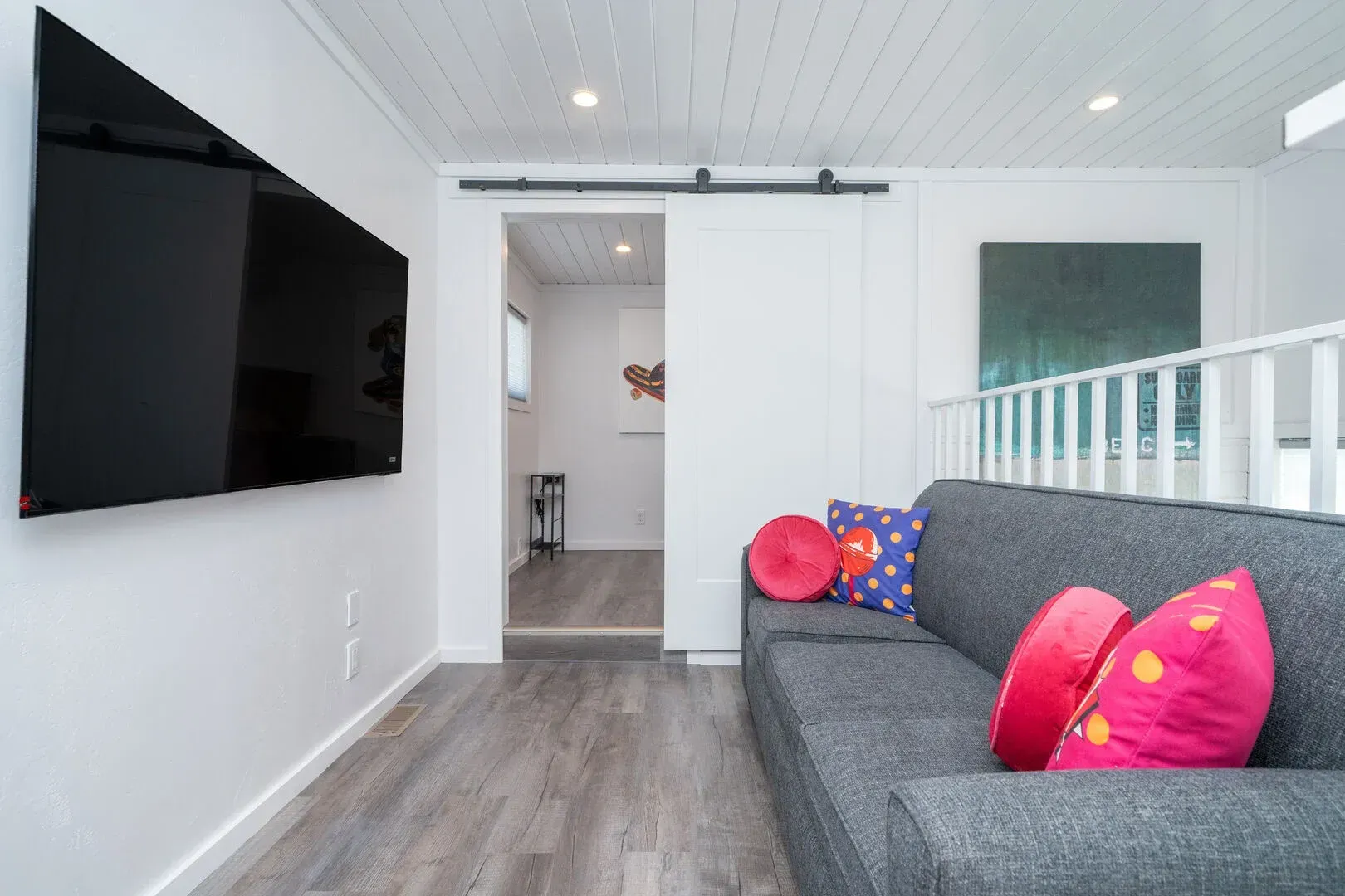 A living room with a couch and a flat screen tv.