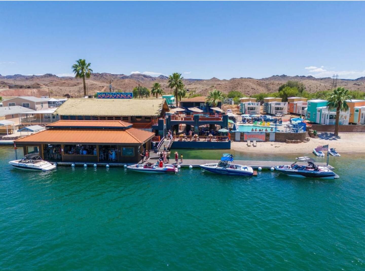 A group of boats are docked in front of a building on a dock.