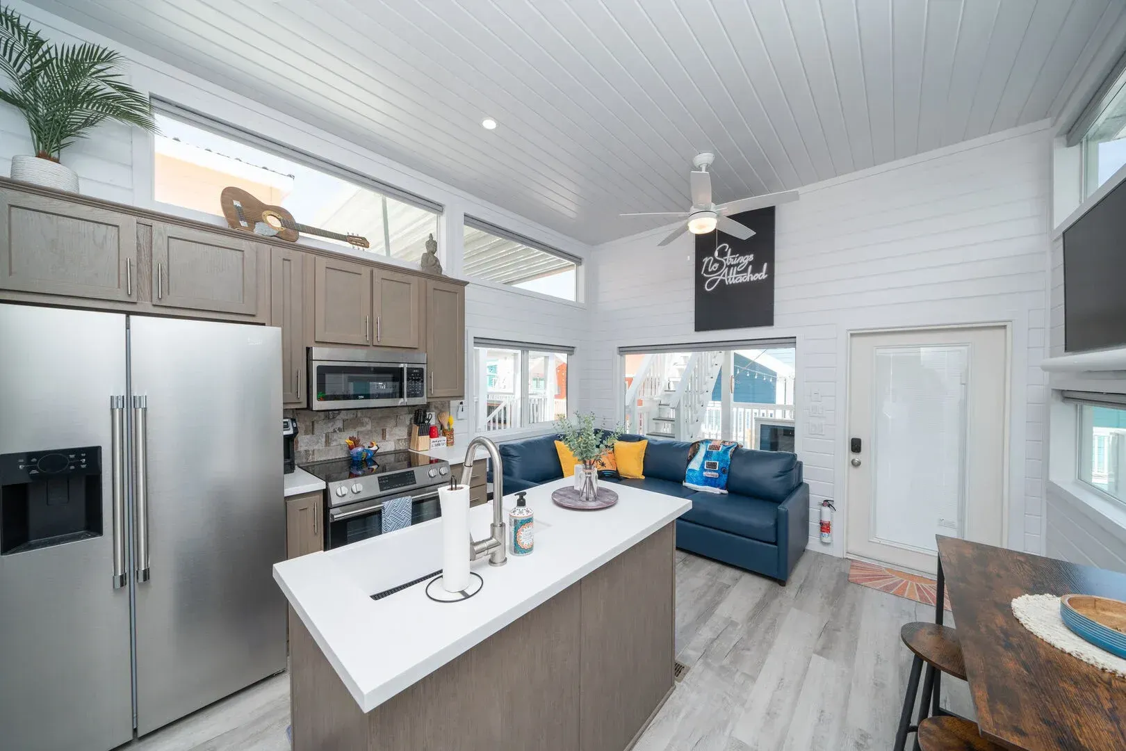 A kitchen with stainless steel appliances and a large island in the middle of the room.