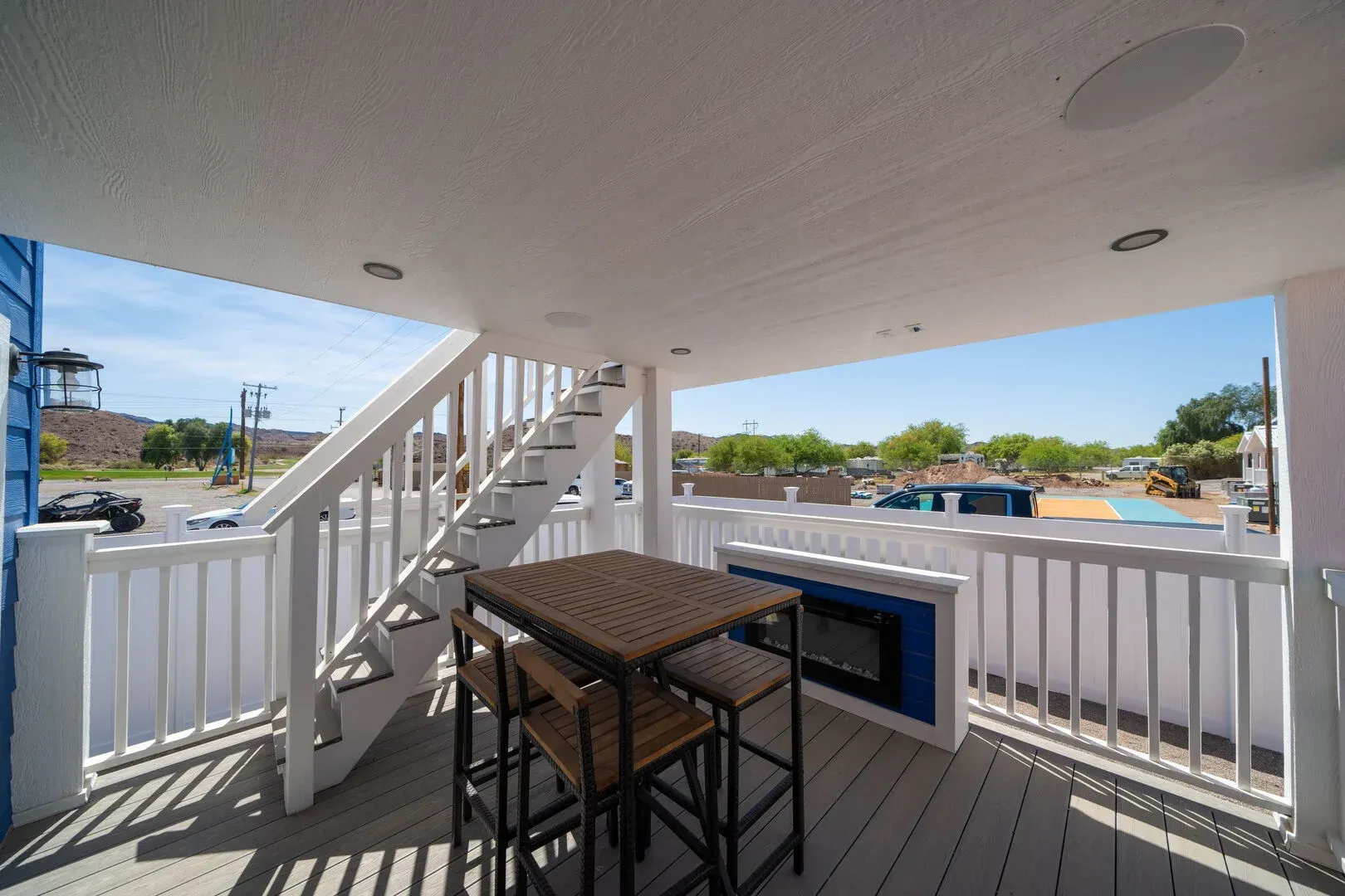 A balcony with a table and chairs and stairs