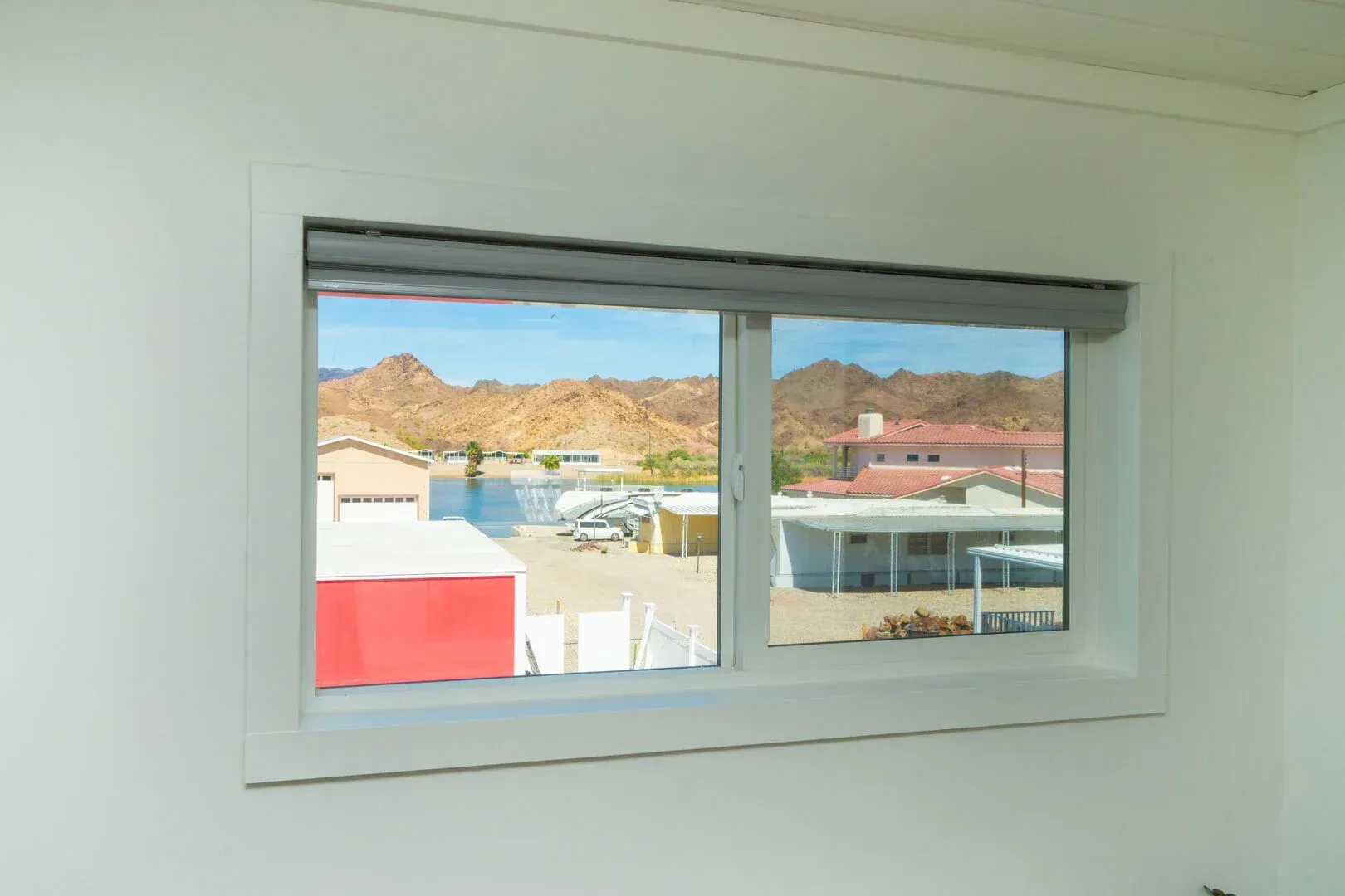A window with a view of a city and mountains