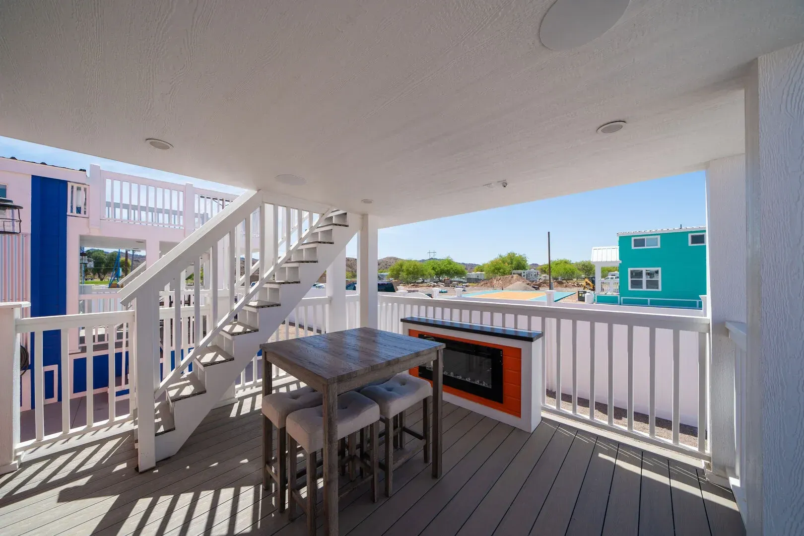 A balcony with a table and chairs and stairs