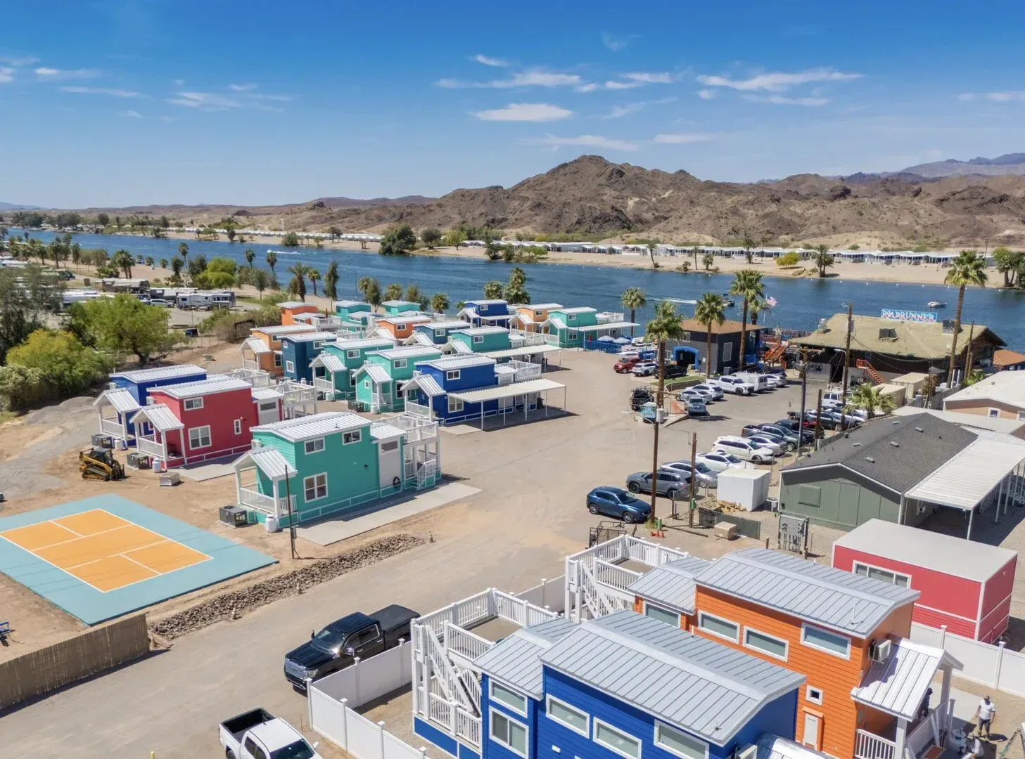 An aerial view of a row of colorful houses next to a body of water.
