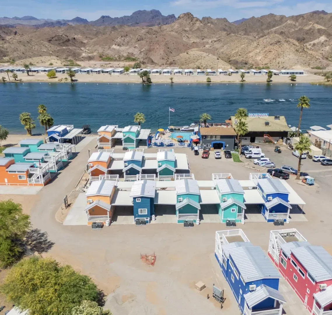 An aerial view of a row of houses next to a body of water
