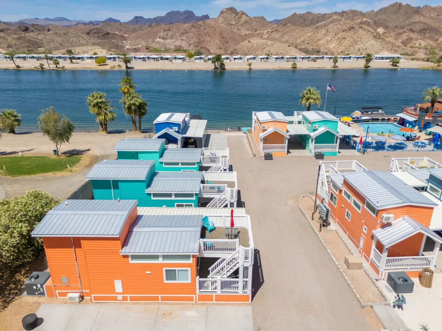 An aerial view of a row of colorful houses next to a body of water.