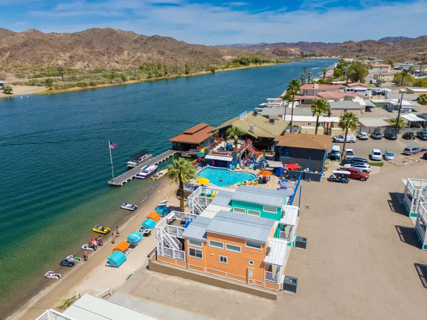 An aerial view of a resort on the shore of a lake.