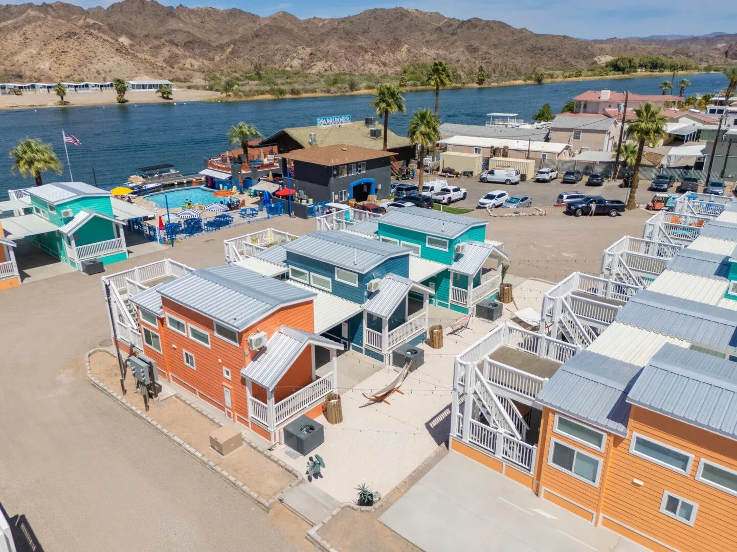 An aerial view of a row of houses next to a body of water.
