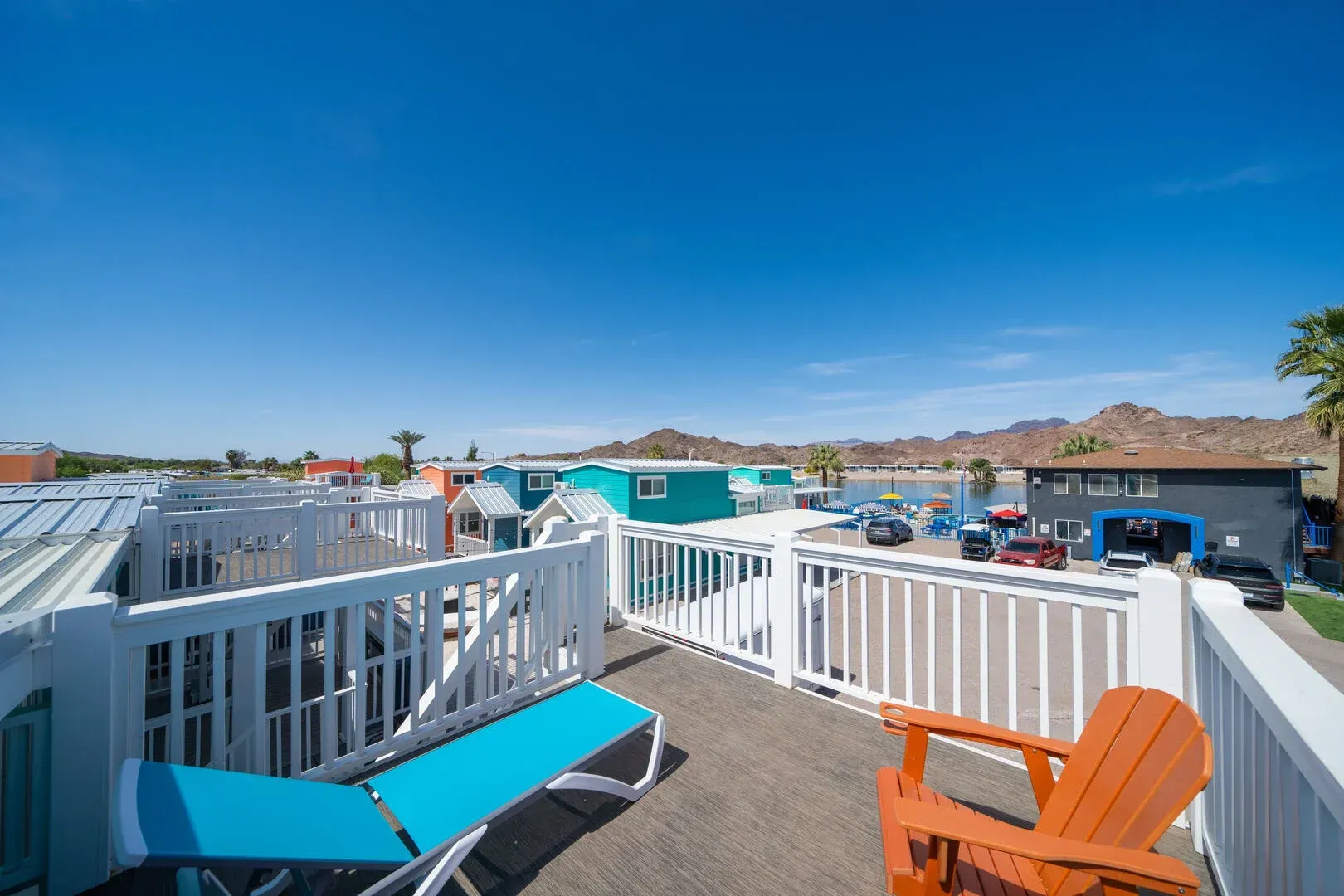 There is a deck with a chair and a bench on it.