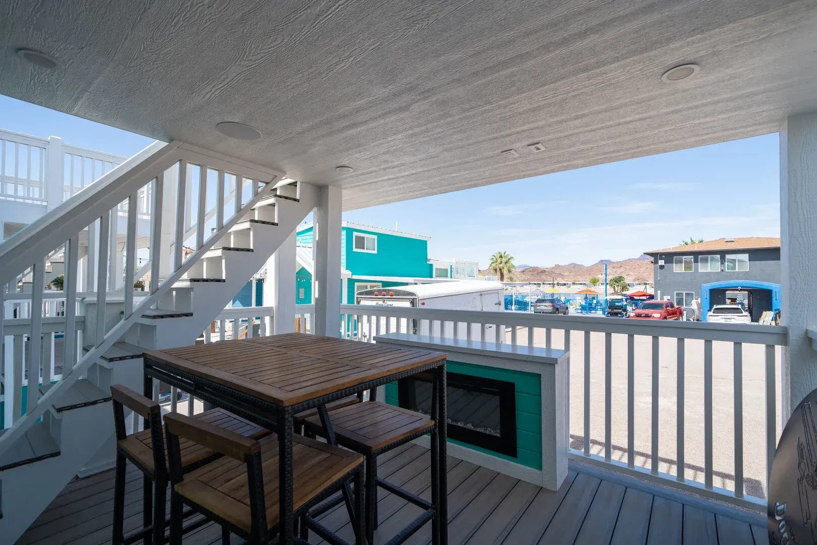 There is a table and chairs on the balcony.