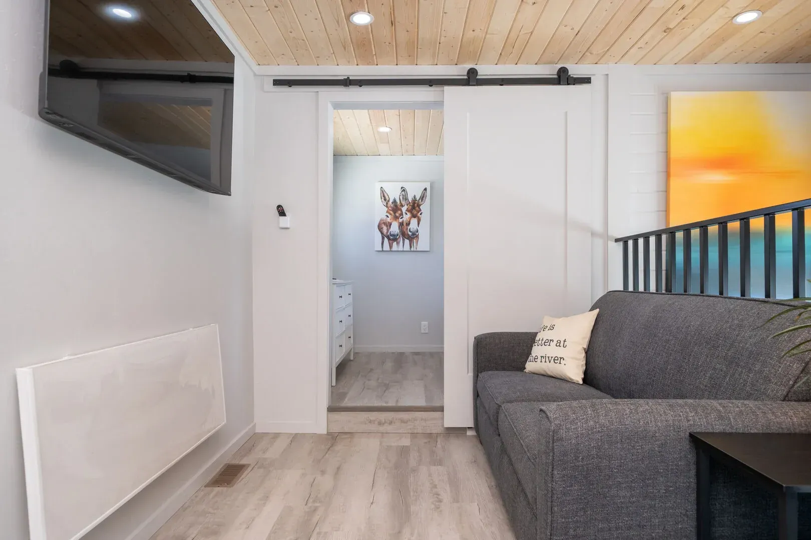 A living room with a couch and a flat screen tv