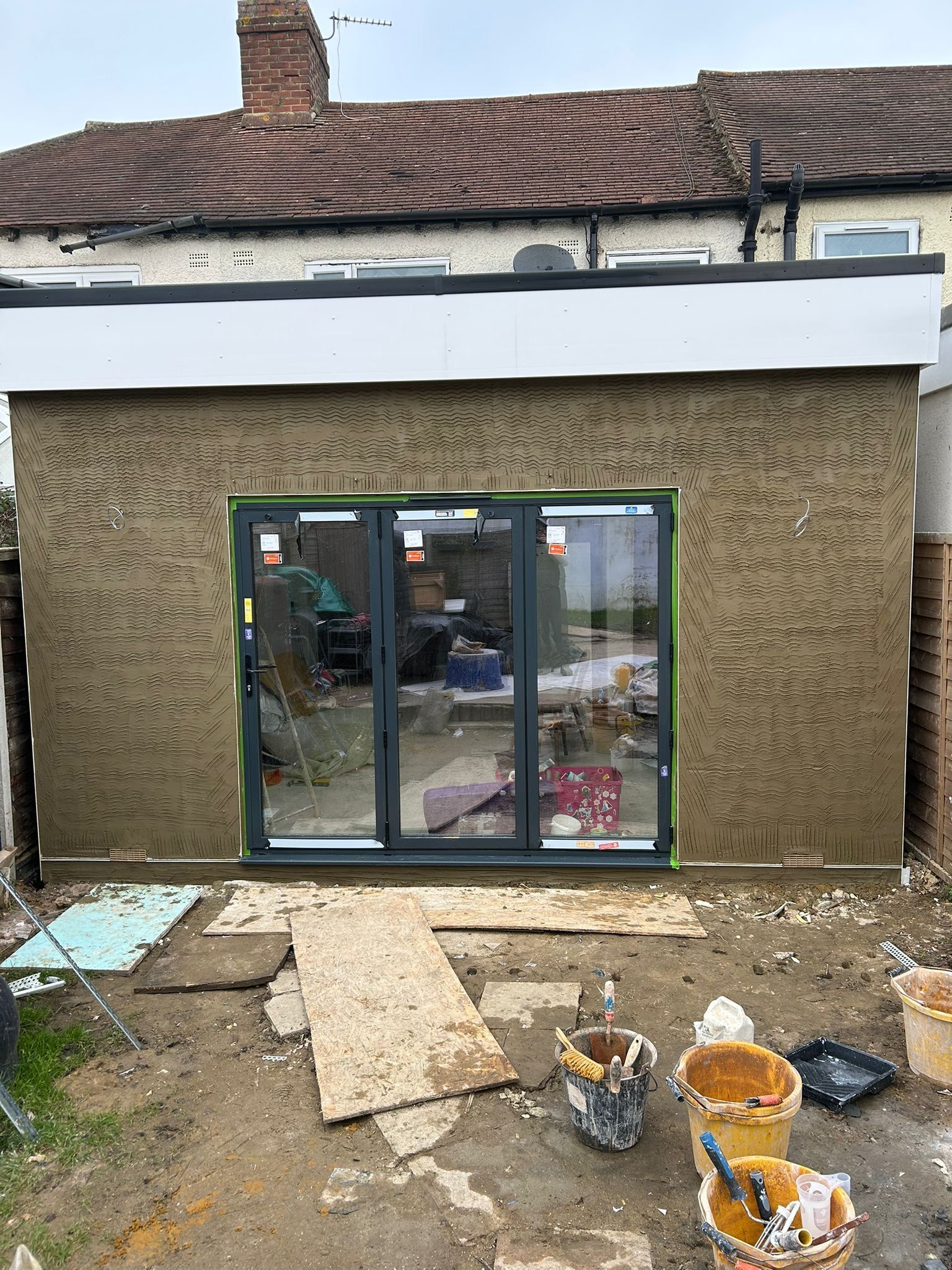 A house is being built with a lot of windows and doors.