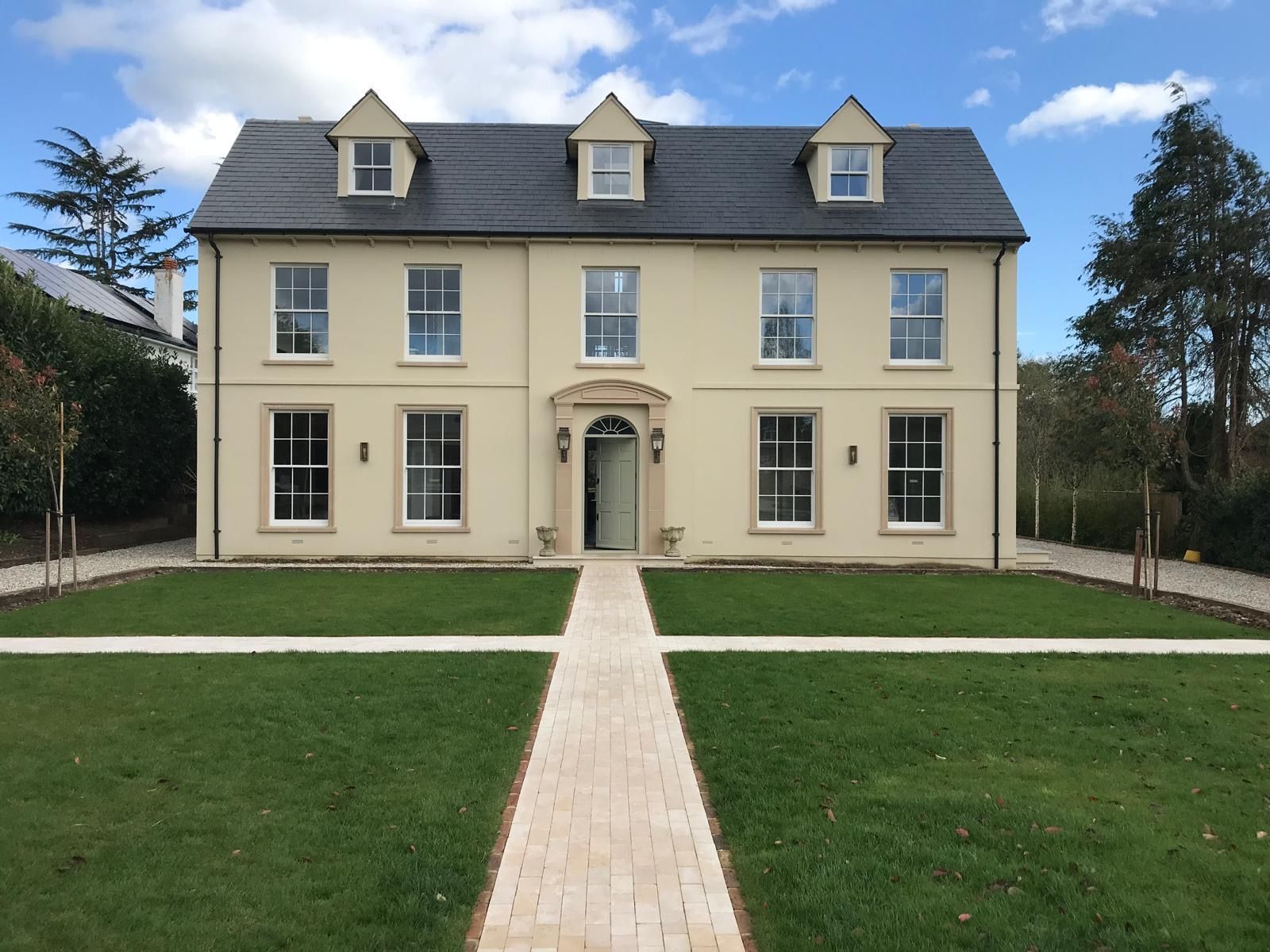 A large house with a brick walkway leading to it