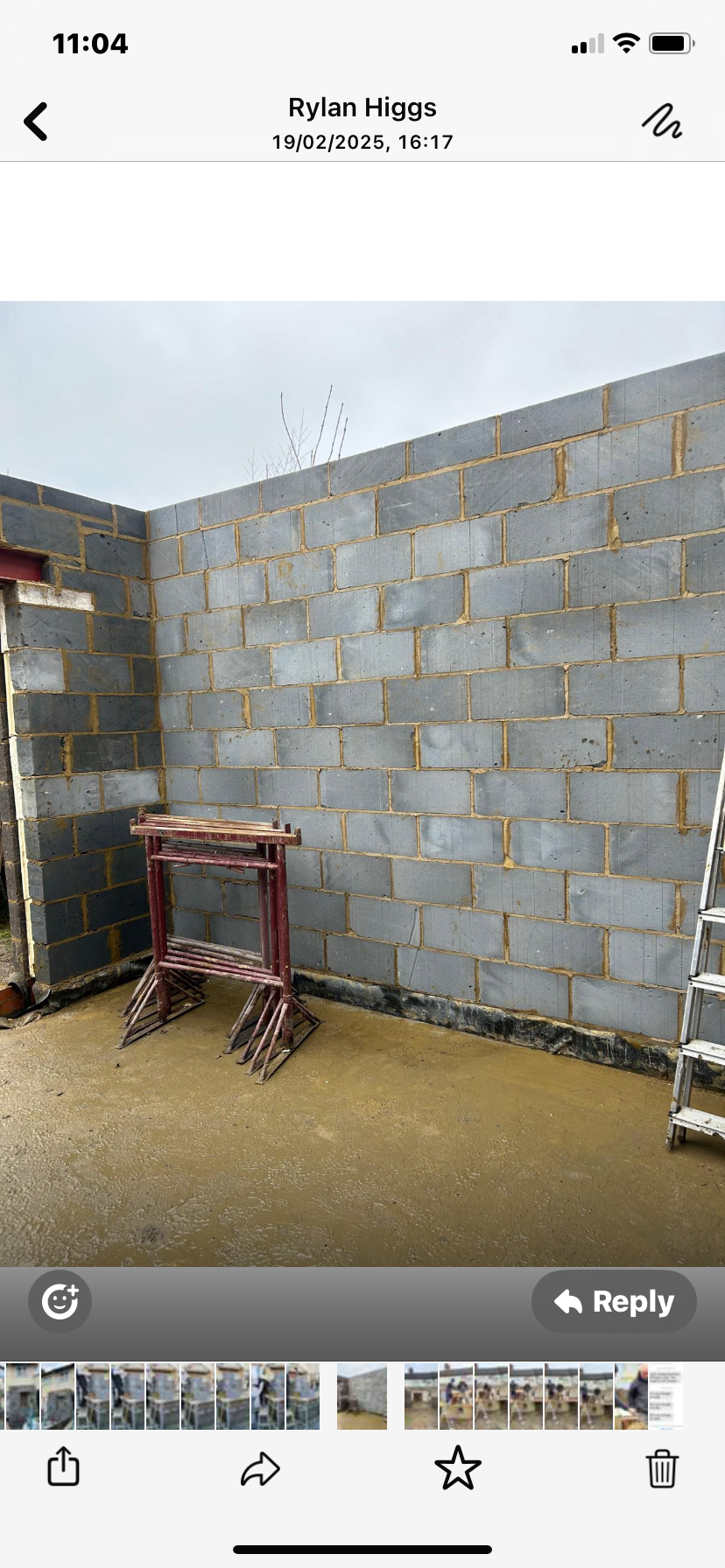A picture of a brick wall being built on a cell phone.