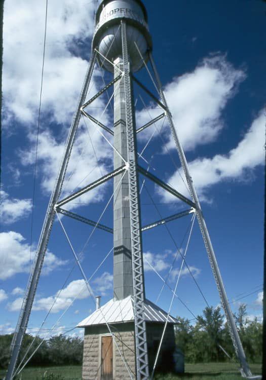 A long wooden table with glasses of wine on it in a restaurant.