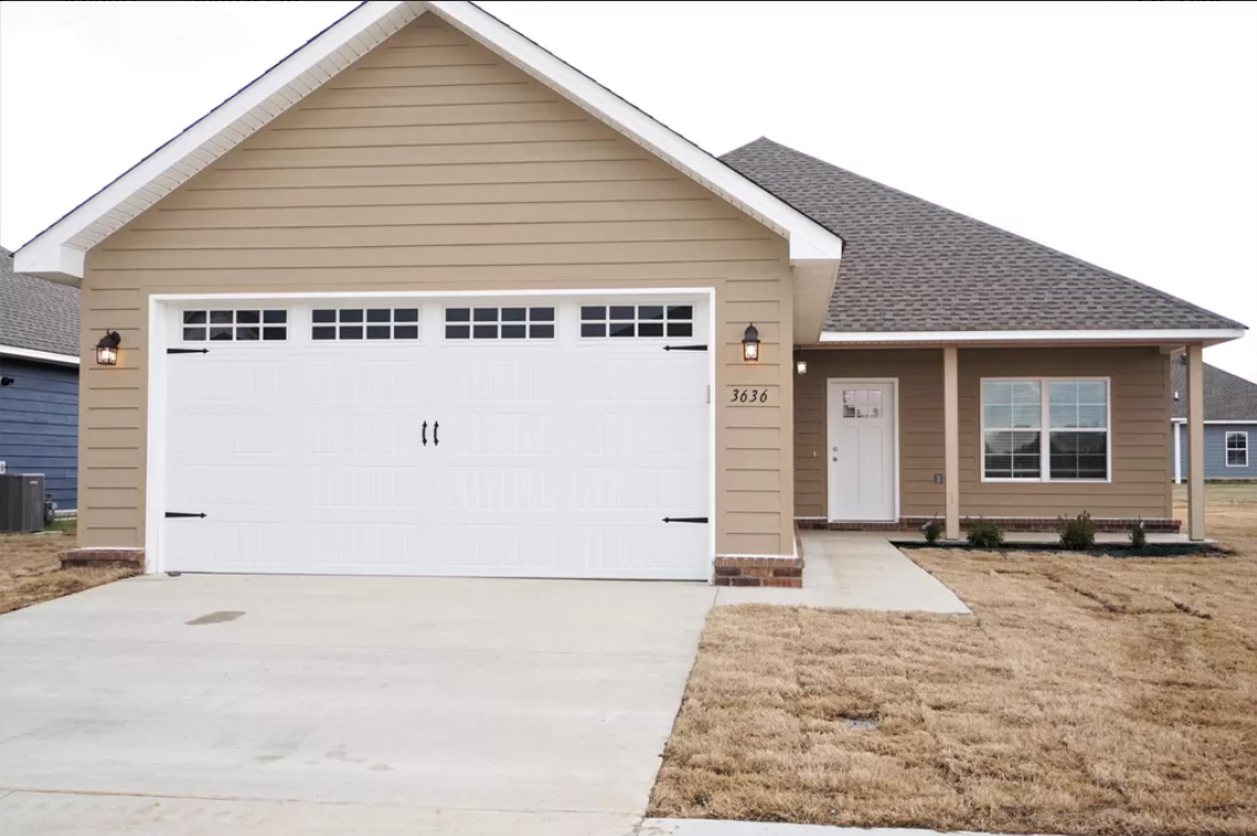 The front of a house with a white garage door