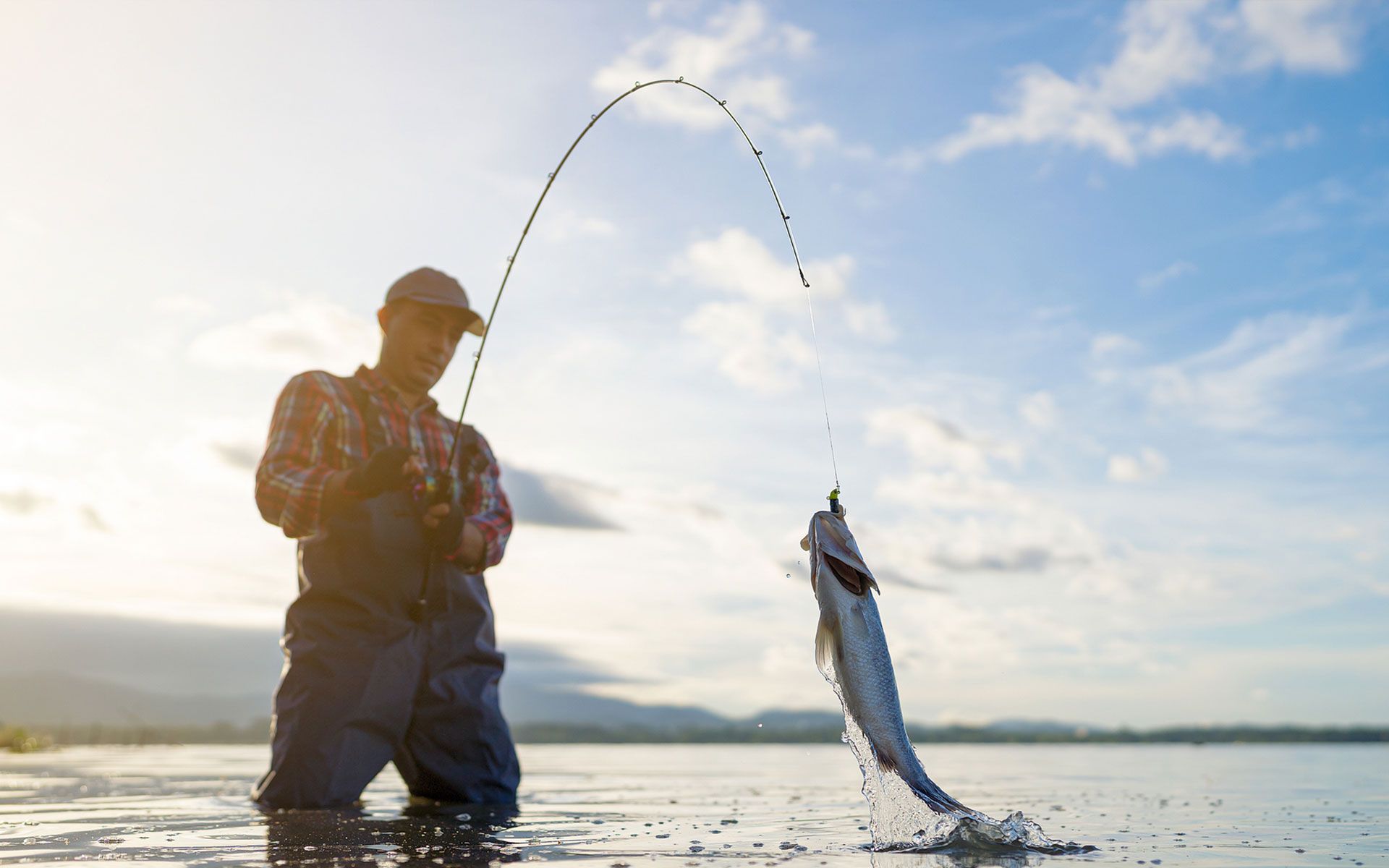 A suitcase is sitting on a bed in a hotel room.