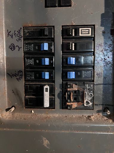 A close up of a electrical panel with graffiti on it.